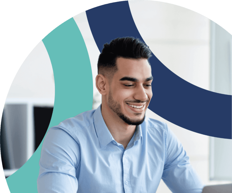 Young man smiling while working on laptop