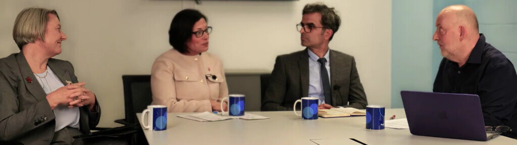 Four people sat at a table having a discussion.