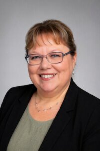 Headshot of a woman wearing glasses and smiling